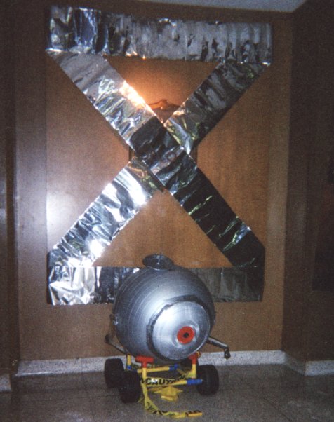 Mascot under big X sign
